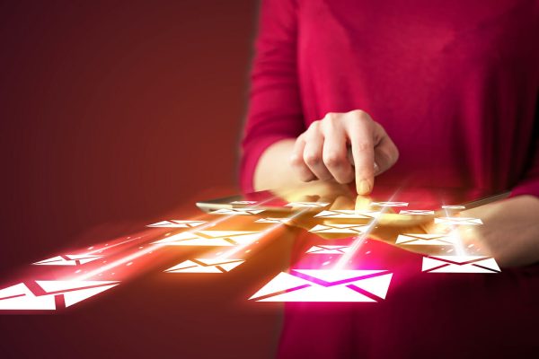 Hand holding tablet and sending email icons concept on background